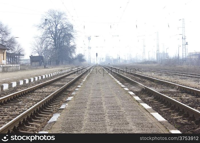 Railroad metal train tracks shot at perspective view.