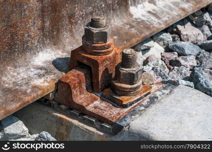 Railroad nut and bolt on background of gravel