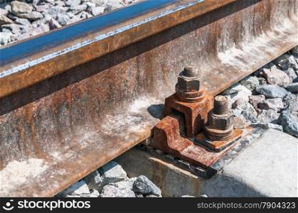 Railroad nut and bolt on background of gravel