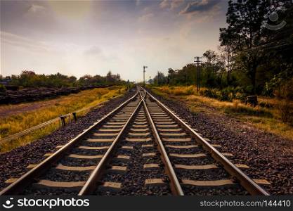 railroad or railway crossing and direct forward to future with sun and cloud blue sky