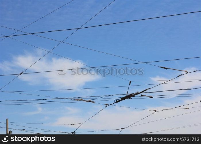 Railroad railway catenary lines against clear blue sky.