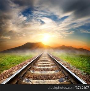Railroad to the mountains at beautiful sunrise