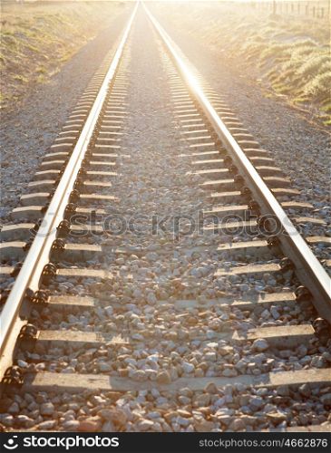 Railroad track sunlit with a beautiful sunset