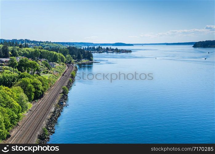 Railroad tracks along the shore of the Tacoma Narrows waterway.