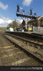 Railroad tracks, platform, semaphore signals and carriages. Grosmont Railway Station, Eskdale, Scarborough, North Yorkshire, England, United Kingdom, North Yorkshire Moors.