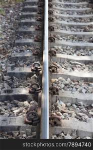 Railroad tracks. With iron bars and cement. A rock base of the tracks.