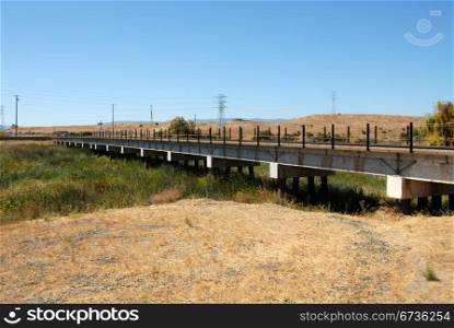 Railroad trestle across overgrown creek, Alviso, California