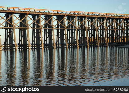 Railroad trestle reflected in the water, Fort Bragg, California