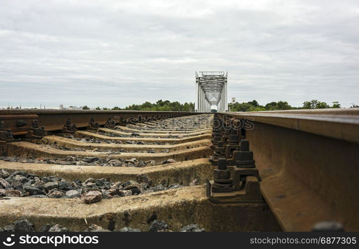 Rails and railway sleepers and railway bridge