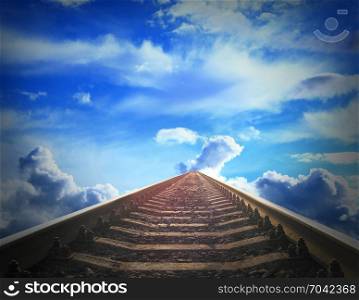 rails going away into the blue cloudy sky. landscape with rails going away into the blue cloudy sky. Cloudy landscape