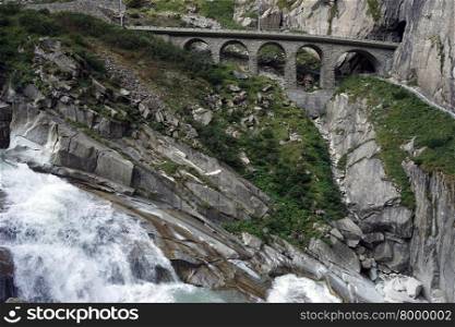 Railway bridge and river near mountain in Switzerland