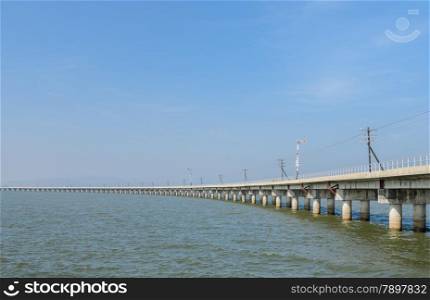 Railway bridge lead across the lake in Thailand