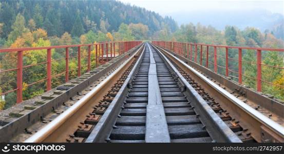 Railway on bridge across mountain river. Autumn, four shots composite picture.