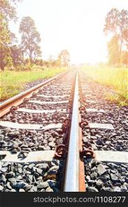 Railway - railroad tracks steel for trains in countryside on nature summer background