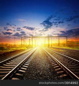 Railway receding into the distance under a sunset sky