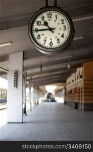 Railway station analog clock. Vertical image