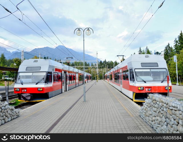 Railway station Strbske pleso with commuter electric trains at platforms in High Tatras.