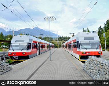 Railway station Strbske pleso with commuter electric trains at platforms in High Tatras.