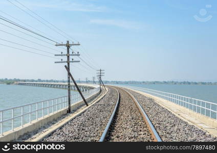 Railway track lead across the lake in Thailand