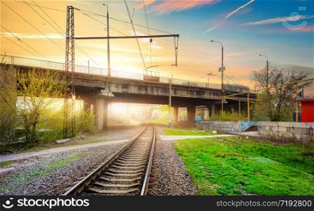 Railway tracks in a rural scene with nice pastel sunset
