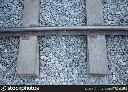 Railway tracks made ??of steel that is placed on a piece of wood. The stone floor was small.