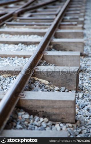 Railway tracks made ??of steel that is placed on a piece of wood. The stone floor was small.