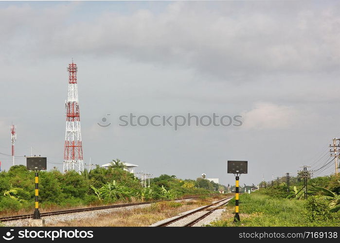 railway with telecommunication station pole.