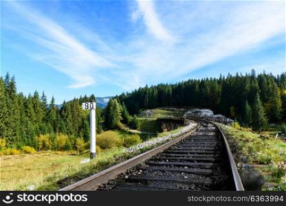 Railways in the Carpathian mountains, stretching into the distance against the blue sky