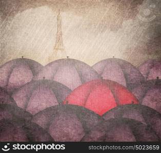 Rain and a red umbrella in a group of blue umbrellas