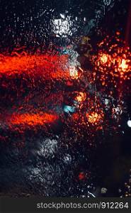 rain and lights on the window at night in the street