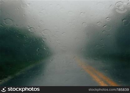 rain drop on glass car on road