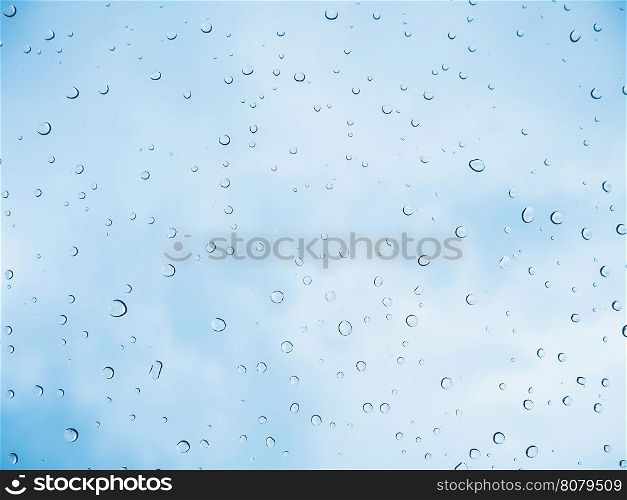 Rain drop stick at glass window over blue sky background