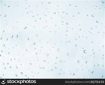 Rain drop stick at glass window over light blue sky background