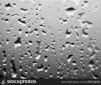 Rain drops on the glass, high resolution black and white image.
