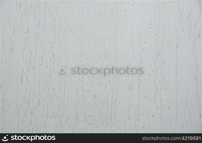 Rain drops on window. Closeup of water drops on a window when it is raining outside