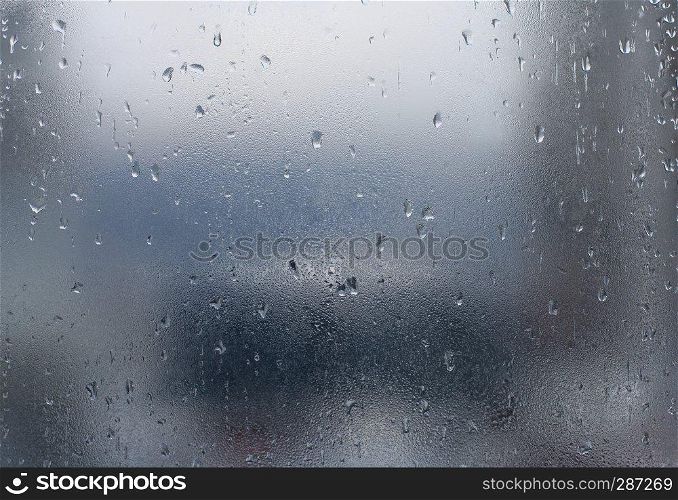 Rain drops on window glass. Abstract background.
