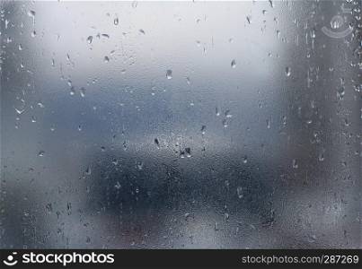 Rain drops on window glass. Abstract background.