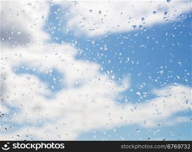 rain drops on window glass with cloud