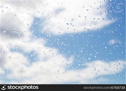 rain drops on window glass with cloud