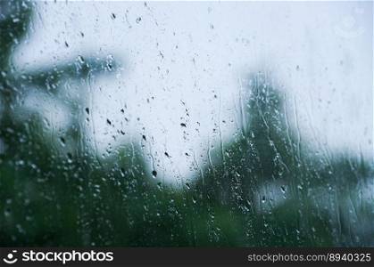 Rain drops on window glasses surface with bokeh background.