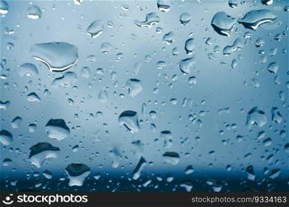 Rain drops on window glasses surface with sunset. drops on glass spray on window background for dark text selective focus