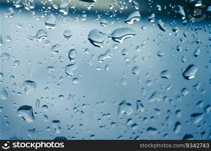 Rain drops on window glasses surface with sunset. drops on glass spray on window background for dark text selective focus