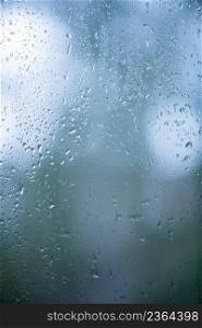 Rain drops on window in background