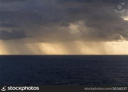 Rain over the Atlantic ocean from heavy storm clouds. Torrential rain from heavy clouds over Atlantic ocean from cruise ship. Rain over the Atlantic ocean from heavy storm clouds