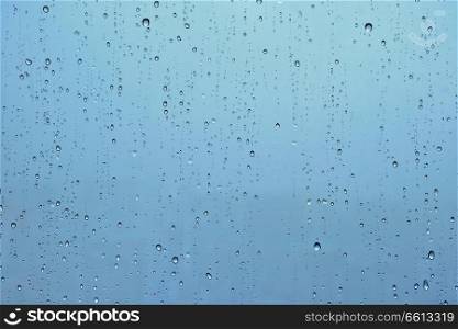 Rain water drops droplets on window glass texture background. Rain drops on window