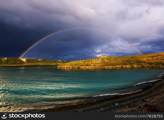 Rainbow above mountains. Beautiful natural landscapes. Picturesque nature.