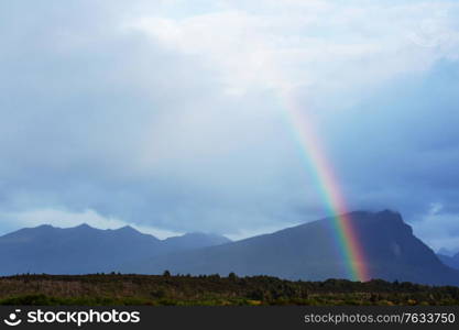 Rainbow above mountains. Beautiful natural landscapes. Picturesque nature.