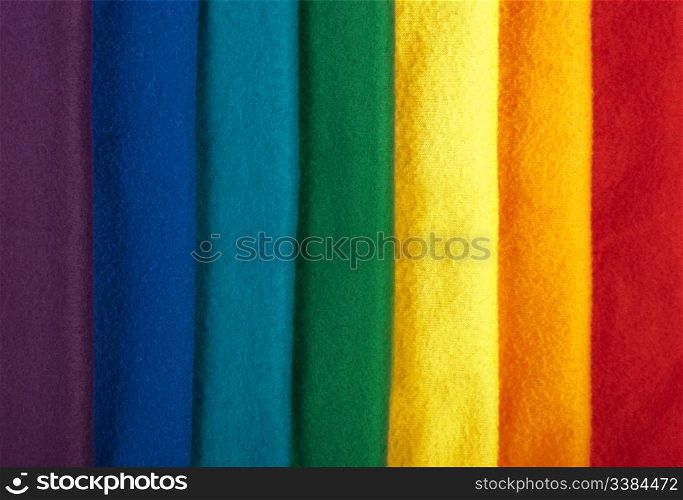 Rainbow background made of colorful winter scarfs