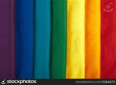 Rainbow background made of colorful winter scarfs