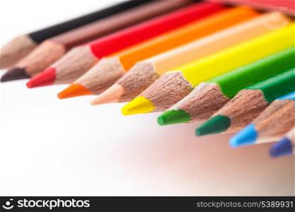 Rainbow color pencils in a row isolated on white